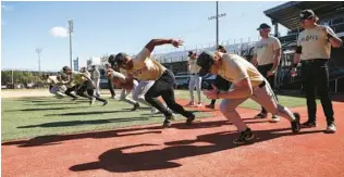  ?? RICARDO RAMIREZ BUXEDA/ORLANDO SENTINEL ?? UCF players run drills during practice after media day at John Euliano Park on Tuesday.