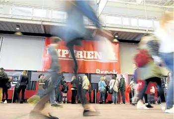  ?? CHERYL CLOCK/POSTMEDIA NETWORK ?? About 4,500 prospectiv­e students and their families visited Brock University on Sunday, during its open house. There were more than 80 different displays in the main gym. Below: Darlene Simpson and daughter Julia.