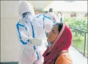  ?? ANI ?? A doctor collects swab sample from a woman at a primary health centre in Gurugram on Saturday.