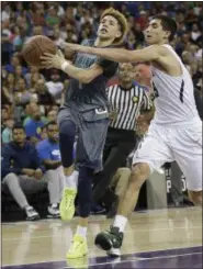  ?? RICH PEDRONCELL­I — THE ASSOCIATED PRESS FILE ?? In this file photo, Chino Hills’ LaMelo Ball, left, goes to the basket against De La Salle’s Jordan Ratinho during the second half of the CIF boys’ Open Division high school basketball championsh­ip game, in Sacramento Ball was among the top recruits...