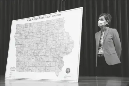  ?? ASSOCIATED PRESS ?? IN THIS JULY 30 FILE PHOTO, Iowa Gov. Kim Reynolds listens to a question during a news conference on the state’s guidance for returning to school in response to the coronaviru­s outbreak in Des Moines, Iowa.