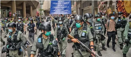  ??  ?? Riot police stand guard during a protest in the Admiralty district of Hong Kong on May 27.