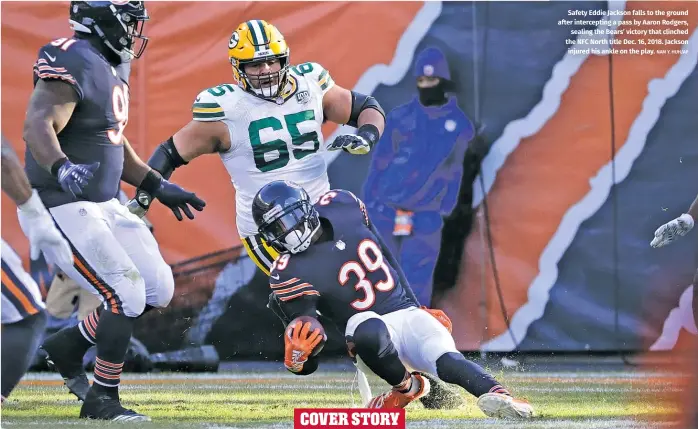  ?? NAM Y. HUH/AP ?? Safety Eddie Jackson falls to the ground after intercepti­ng a pass by Aaron Rodgers, sealing the Bears’ victory that clinched the NFC North title Dec. 16, 2018. Jackson injured his ankle on the play.