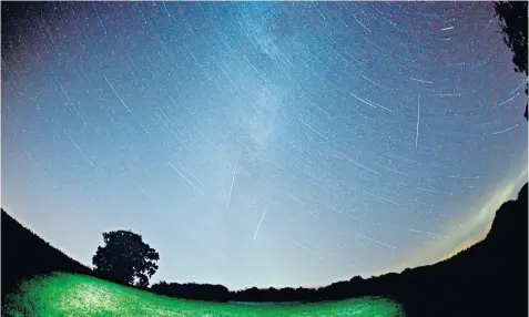  ??  ?? Sky at night: Tim Gregory, below, shares his fascinatio­n with meteorites; Perseid meteors fall to Earth, above