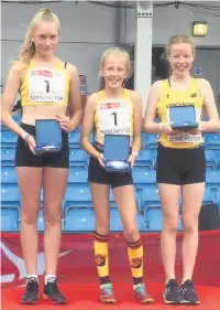  ??  ?? ●●Darcy Breen, Saffron Meade and Freya Murdoch collect gold medals for 3 x 500m relay