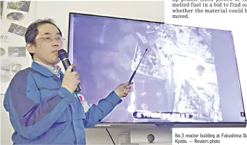  ??  ?? A Tepco worker explains the operation in the No.3 reactor building at Fukushima Daiichi nuclear power plant in this photo taken by Kyodo. — Reuters photo