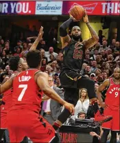  ?? GREGORY SHAMUS / GETTY IMAGES ?? LeBron James hits a game-winning shot over the outstretch­ed hand of Toronto’s OG Anunoby in Game 3 of their Eastern Conference semifinal series Saturday in Cleveland.