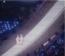  ?? PAUL CHIASSON/THE CANADIAN PRESS ?? After climbing the staircase to the top of the stadium, the torchbeari­ng hockey players, Jong Syu Hyon, left, of North Korea’s women team, and Park Jong-ah, of South Korea, stood together in a symbolic moment.