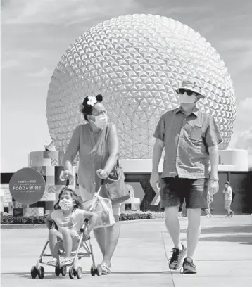  ?? JOE BURBANK/ORLANDO SENTINEL ?? Guests arrive to attend the official reopening day of Epcot on July 15 at Walt Disney World.