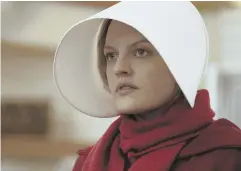  ?? AP FILE PHOTO ?? FICTION, NOT FACT: Over-the-top praise for ‘The Handmaid’s Tale,’ starring Elisabeth Moss, likens this dystopian state to American democracy under an elected president.
