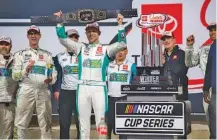  ?? AP PHOTO/MIKE CAUDILL ?? Denny Hamlin celebrates after winning a NASCAR Cup Series race at Richmond Raceway on March 31.