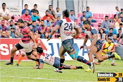  ??  ?? centre Sandun Herath goes past Kandy defenders to score their first try - Pic by Sameera Weerasekar­a