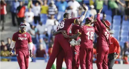  ??  ?? ANTIGUA: West Indies’ captain Jason Holder (98) is surrounded by teammates after beating India by 11 runs in the fourth ODI cricket match at the Sir Vivian Richards Stadium in North Sound, Antigua and Barbuda, Sunday. —AP