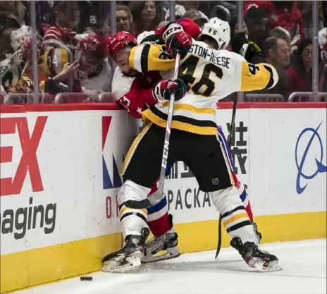  ?? Scott Taetsch/Getty Images ?? Zach Aston-Reese checks Washington’s Radko Gudas along the boards in a game in February. Part of the lockdown fourth line, Aston-Reese had a .693 defensive zone start percentage.