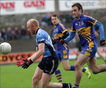  ??  ?? Cian McGovern of St Anne’s is chased by James Cooney of Gusserane.