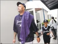  ?? Lynne Sladky / Associated Press ?? Yankees starting pitcher CC Sabathia leaves a news conference with his son Carter on Saturday.