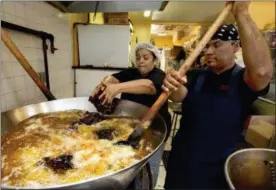  ?? RICHARD DREW — THE ASSOCIATED PRESS ?? Christina Mora and Franco Hernandez start a new batch of mole at the headquarte­rs of Mole Poblano Asuncion Corp., in the Bushwick neighborho­od of Brooklyn borough of New York, Tuesday. This family-run business, that produces about 1,600 pounds of mole...