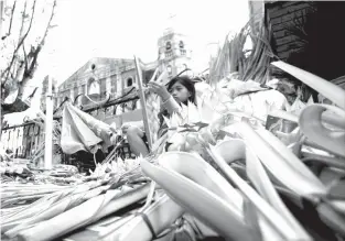  ?? A young girl from Laguna makes “palaspas” (woven palm leaves) at the front yard of the Immaculate Conception parish church in Dasmariñas, Cavite, to be sold this Palm Sunday as the Catholic faithfuls start the observance of the Holy Week. ?? LAL- LO, Cagayan: