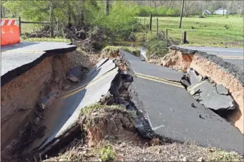  ?? Blake Silvers ?? A portion of Moore’s Ferry Road at Miller Loop was washed away Thursday during heavy rains, a good example of why drivers should never try and cross moving water in the roadway.