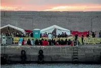  ?? AP ?? Migrants sit in Arguinegui­n port after their rescue in Gran Canaria island.