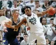  ?? AL GOLDIS — THE ASSOCIATED PRESS ?? Michigan State’s Nick Ward, right, maneuvers against Michigan’s Moritz Wagner during the second half of an NCAA college basketball game, Saturday in East Lansing, Mich. Michigan won 82-72.