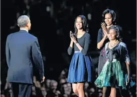  ?? Spencer Platt / Getty Images ?? A victorious President Obama is greeted by his family.