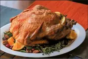  ?? Food styling/KELLY BRANT Arkansas Democrat-Gazette/JOHN SYKES JR. ?? A ready-to-roast turkey is dressed for the table. Ready-to-roast turkeys go from freezer to oven to table in just 3 to 4 hours.