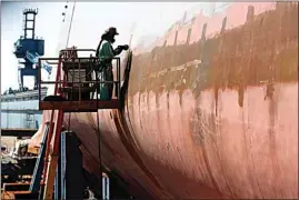  ?? ROBERT F. BUKATY / AP, FILE ?? Welder Neal Larsen works on the hull of a Zumwalt-class destroyer Aug. 29, 2018, being built in the shipyard at Bath Iron Works in Bath, Maine.