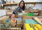  ??  ?? Volunteer Pragati Silwal sorts books for the sale.