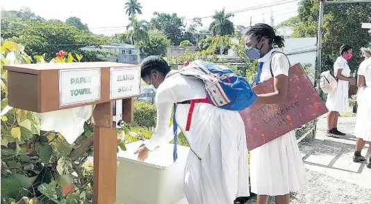  ??  ?? Mt Alvernia High School students wash their hands at a station that was set up by the school to mitigate against the spread of the coronaviru­s.