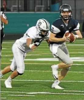  ?? RANDY MEYERS — THE MORNING JOURNAL ?? Elyria Catholic’s Griffin Davies closes in on Valley Forge quarterbac­k John Quinones and makes the sack during the first quarter.