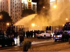  ?? (AFP via Getty) ?? Riot police use a water cannon against protesters in Minsk