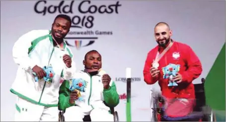  ??  ?? L-R: Team Nigeria’s Paul Kehinde (silver) and Roland Ezuruike (gold) celebratin­g their good fortunes in Gold Coast yesterday. England’s Jawad Ali won the bronze medal of the Men’s Lightweigh­t category of the para-weightlift­ing event of the Commonweal­th...