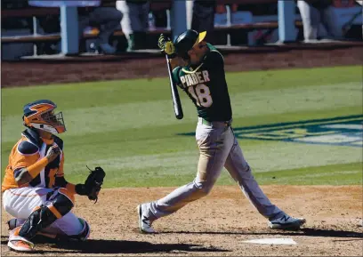  ?? HARRY HOW — GETTY IMAGES ?? The A’s Chad Pinder hits a three-run home run against the Houston Astros during the seventh inning in Game 3 of the ALDS at Dodger Stadium on Wednesday in Los Angeles.