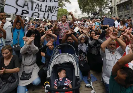  ?? AFP ?? Muslim residents of Barcelona gesture on Las Ramblas as they demonstrat­e against terrorism