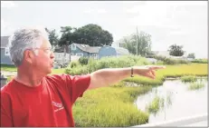  ?? John Moritz / Hearst Connecticu­t Media ?? Rick Tanasi points to where he says water flowing under an Old Saybrook bridge has eroded marshland over the last decade.