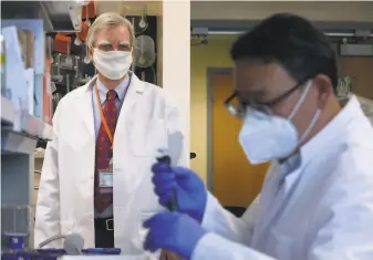  ?? Paul Chinn / The Chronicle ?? Verndari CEO Dr. Daniel Henderson (left) is leading the work on a coronaviru­s vaccine patch.