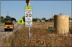  ?? RJ SANGOSTI — THE DENVER POST ?? A school bus drives past an old K.P. Kauffman Co. well site near Legacy Elementary School on Thursday in Frederick.