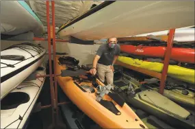  ?? Erik Trautmann / Hearst Connecticu­t Media ?? Scott Maxwell, manager of the Outdoor Sports Center, displays some of the outdoor sporting equipment at the store in Wilton earlier this month. More people have beeen visiting state parks and beaches as an alternativ­e to isolation at home.