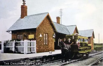 ?? Author’s Collection ?? A circa 1900 postcard depicts the singleplat­form Port Carlisle station and the ‘Dandy’ horse-drawn tram waiting to depart for Drumburgh, where there was an island platform, a single siding on the branch and another at the station. Hand-tinted postcards of this era are notorious for their artist’s license in relation to colours used, but, remarkably, NBR car No 1 has been saved as part of the National Collection and it is now restored in a deep red livery, with ‘Port’ and ‘Carlisle’ painted just below roof level either side of the central door, ‘N. B. R.’ and ‘No. 1.’ on the correspond­ing lower panels, and ‘For 1st & 2nd class passengers only’ on the door itself. Four of these ‘Dandy’ vehicles were built by the NBR at its St Margarets Works, and clearly they owe much to stagecoach design, including the provision of luggage space on the roof. Officially the NBR livery for coaching stock was ‘crimson lake’ but it has a few alternativ­e descriptio­ns, including a reference that a brown undercoat was given an alizarin crimson topcoat.