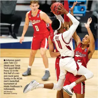  ?? AP Photo/ Michael Conroy ?? ■ Arkansas guard Jalen Tate (11) shoots over Texas Tech guard Micah Peavy (5) in the first half of a second-round game Sunday in the NCAA men’s basketball tournament at Hinkle Fieldhouse in Indianapol­is.