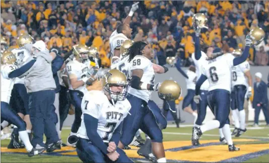  ?? Jeff Gentner/Associated Press ?? Steve Malinchak, front, and the Panthers celebrate their 13-9 upset win over No.2 West Virginia Dec. 1, 2007, in Morgantown.