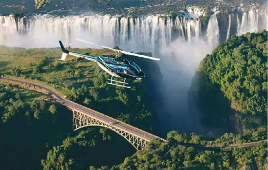  ??  ?? Thundering mist … A helicopter flight over the falls.
