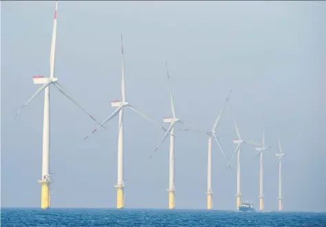  ?? TOBIAS SCHWARZ/AFP/GETTY IMAGES ?? A new report forecasts energy companies could spend billions on renewable projects between now and 2035, as returns from wind power projects and solar projects “stack up” favourably against higher-cost oil and gas plays and demand grows for renewables.