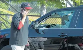  ?? Cliff Owen Associated Press ?? REP. BRAD WENSTRUP (R-Ohio) talks on a cellphone after the early morning attack. The White House and Congress canceled official business for the day.