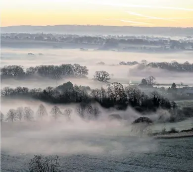  ??  ?? A wintry fog rolls over the fields in Pewsey, Wiltshire, as Britain braces for plummeting temperatur­es