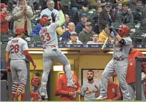  ?? BENNY SIEU / USA TODAY SPORTS ?? The Cardinals’ Marcell Ozuna celebrates with Yadier Molina after hitting a two-run homer in the third inning Tuesday night.