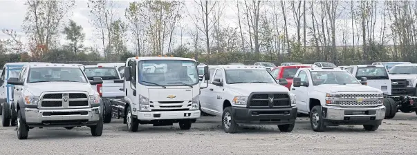  ??  ?? Chassis Cab trucks sit in a lot waiting to be upfitted for commercial use in Flint, Michigan.