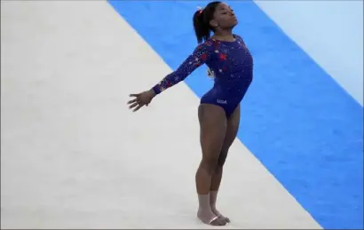  ?? Ashley Landis/Associated Press ?? Simone Biles performs her floor exercise routine during the women’s artistic gymnastic qualificat­ions at the 2020 Summer Olympics on July 25 in Tokyo.