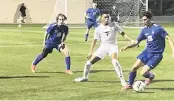  ?? BILL DALEY Special to the Miami Herald ?? Pembroke Pines Charter’s Justin Treasure defends against a Panama City Beach Arnold player during Tuesday night’s Class 5A boys soccer state semifinal game at Spec Martin Stadium in DeLand.